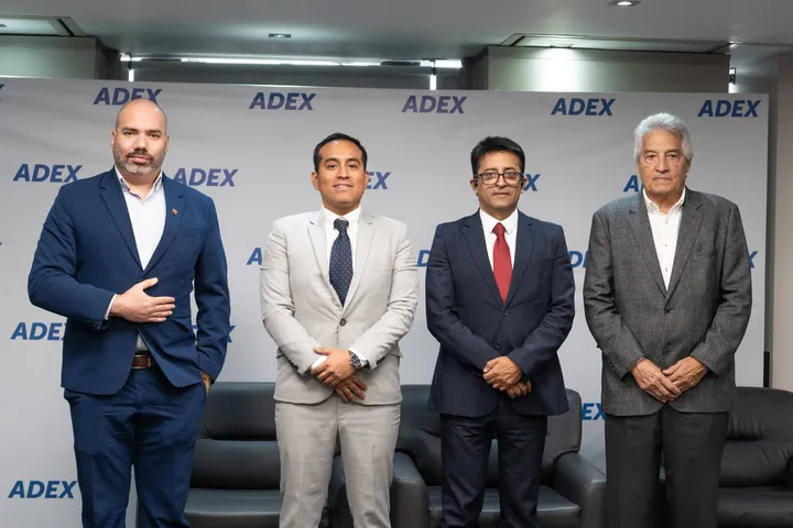 Four representatives standing together in front of an ADEX backdrop.