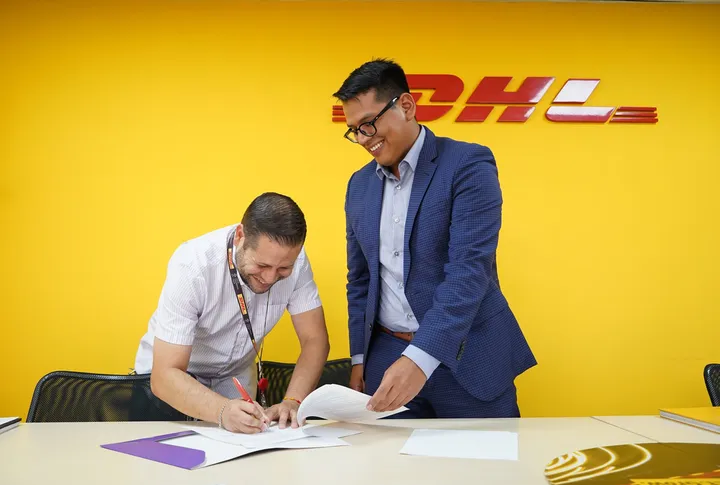 Signing the SmartBrands and DHL agreement.