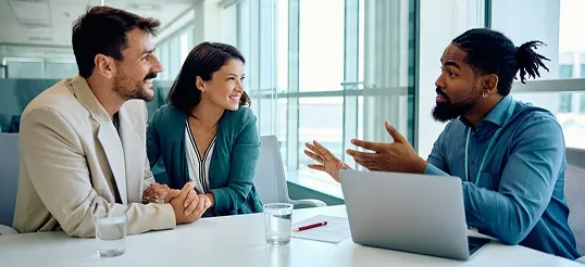 Adviser talking with a couple in an office meeting