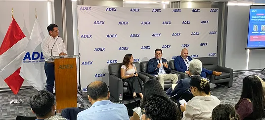 Speaker panel in front of an audience at an ADEX event